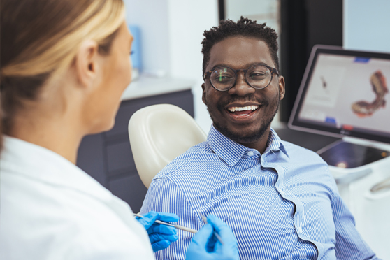 Man in dentist chair smiling