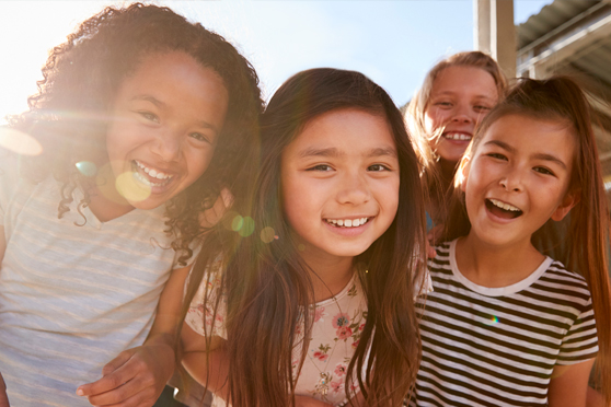 Group of school age kids smiling at the camera